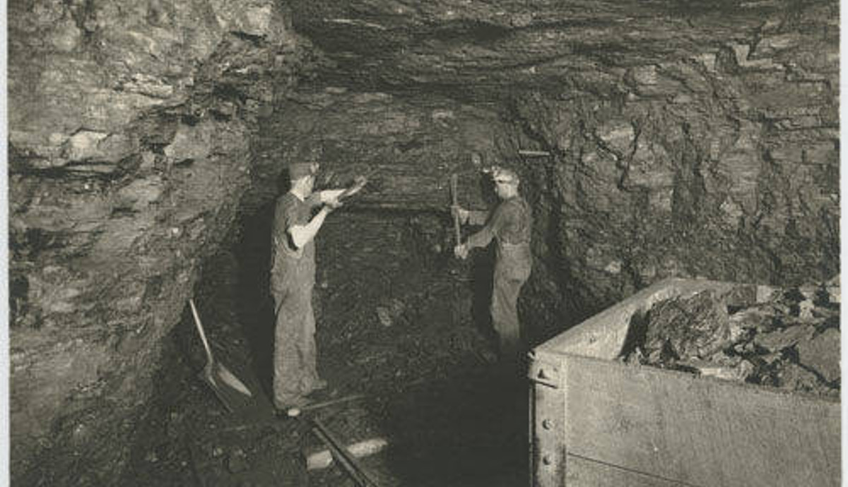 Two miners digging coal in a coal mine in North Dakota, c. 1925. (Source: dp.la)